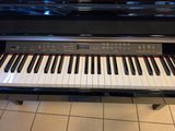 a piano that is sitting on a tile floor