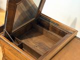 a small wooden table with a mirror on top of it