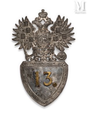 an old metal shield with a coat of arms and two birds on it