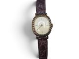 an image of a close up of a wrist watch on a white surface