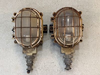 pair of antique brass wall sconces with caged lamps