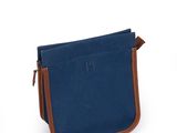 a small blue bag with a brown handle on a white background