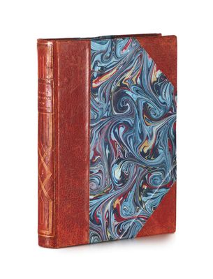 an old book with a blue and red cover on a white background