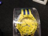 a yellow and blue watch in a clear box