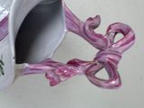 a small vase with a pink bow on it