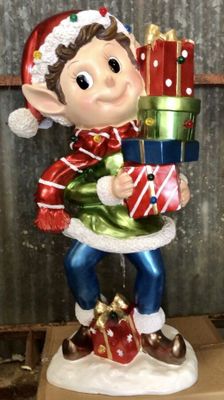 a statue of a elf holding a stack of presents