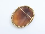 a close up of a broochle with a gold wire around it