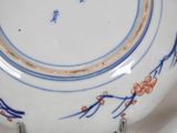 a blue and white plate with a design on it