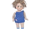 a small doll that is wearing a blue dress and socks
