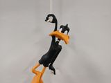 a close up of a toy duck hanging from a string