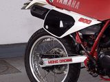 a red and white yamaha motorcycle parked in a garage