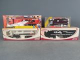 two boxed toy trains are sitting on a table next to each other