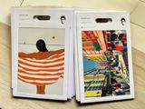two magazines sitting on a table with pictures of people on them