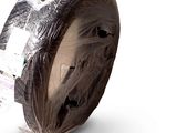 a roll of tape wrapped in plastic on a white surface