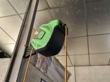 une photo d'un mètre ruban vert et noir fixé à un poteau métallique