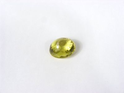 gros plan d'une pierre de saphir jaune sur une surface blanche