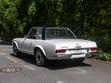 a silver car that is parked on the side of the road