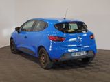 the rear end of a blue car in a room with a checkered floor