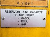 a sign on the side of a yellow machine