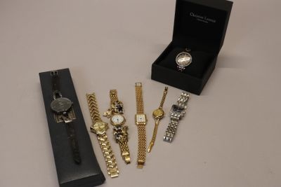 three watches and a watch box are sitting on a table