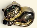 a gold and silver cat brooch with green eyes