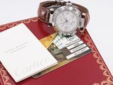 a watch and a book sitting on a table