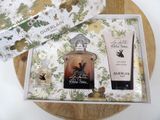 a bottle of perfume and a bottle of body lotion in a box