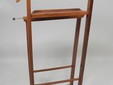 a wooden coat rack with a wooden hanger on it