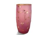 a pink vase with gold designs on it on a white surface