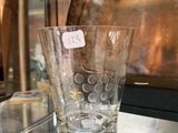 a glass vase sitting on a glass shelf in a glass case
