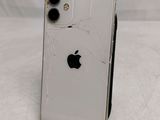 a broken iphone sitting on a stand on a table