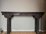 a wooden table in the corner of a room