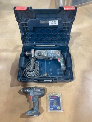 an image of a corded drill and two batteries in a case