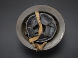 a metal bowl with a piece of wood sticking out of it