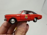 someone is holding a toy car in their hand on a white surface