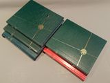 three books are stacked on top of each other on a table