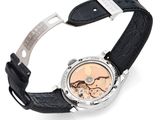 a close up of a watch on a white surface with a black strap