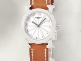 a close up of a watch on a white surface