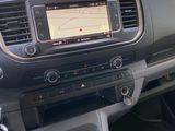 the interior of a car with a steering wheel and dashboard controls