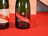 two bottles of champagne sitting on a red table