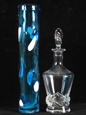 two glass vases sitting next to each other on a table