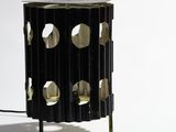 a lamp that has holes in it on a table
