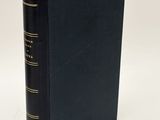 a black book with gold trim on a white background