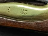 an image of a close up of a rifle on a table