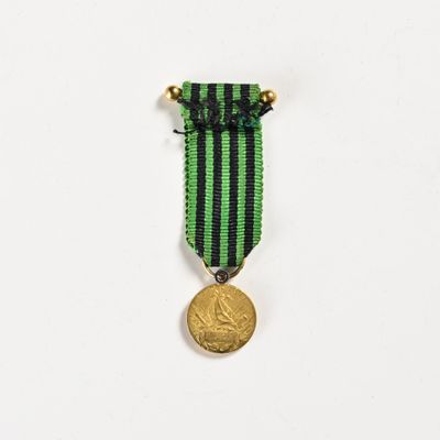 a close up of a medal on a white surface