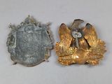 two pieces of silver and gold on a white surface