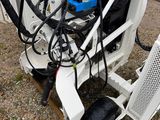 a machine that is sitting on the ground in front of a building