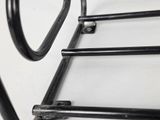 a close up of a metal ladder on a white surface