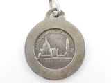 an image of a silver medal with a picture of a church