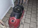 a red and black machine on the floor in a room